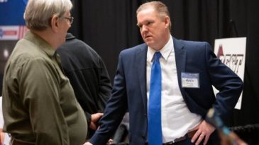 Kevin Kirkham, with NIPSCO, on right, speaks with Bob Spatz, with Carbon Day Automotive, during the South Shore Clean Cities annual meeting on Tuesday, Feb. 26, 2019. (Kyle Telechan / Post-Tribune)